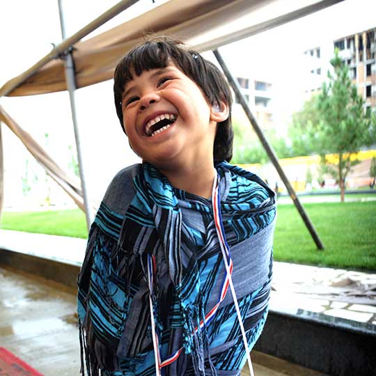 little kid happy with a hearing aid